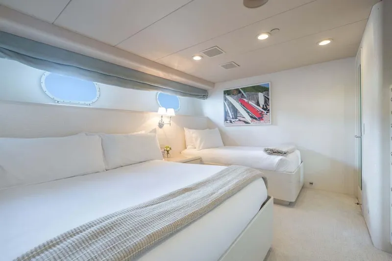 Slide: The Image of Luxurious bedroom interior on a 1995 Christensen Tri-Deck yacht, featuring twin beds and elegant decor. - 23
