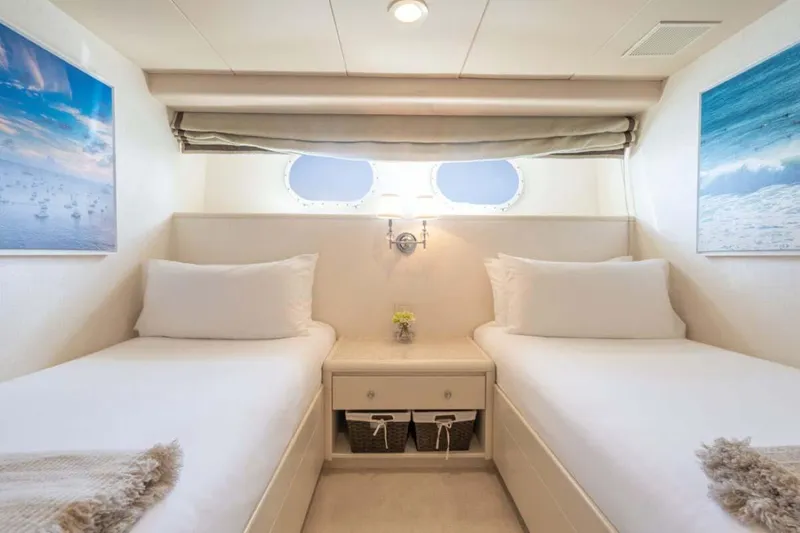 Slide: The Image of Luxurious twin cabin on 1995 Christensen Tri-Deck yacht, featuring elegant decor and ocean-themed artwork. - 25