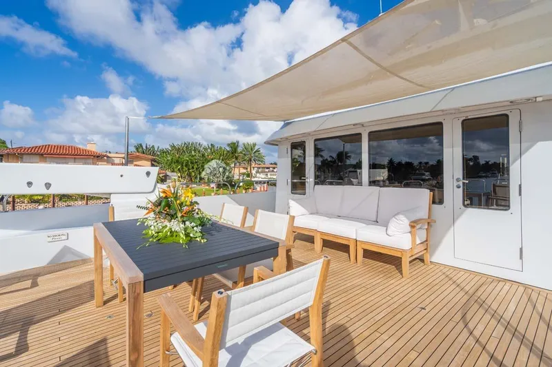 Slide: The Image of Luxurious 1995 Christensen Tri-Deck yacht deck with elegant seating and dining area. - 30