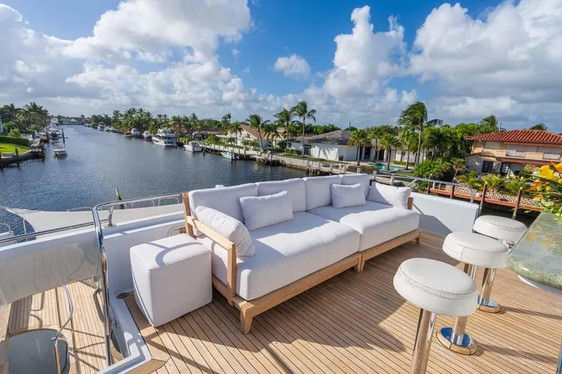 Slide: The Image of Luxurious 1995 Christensen Tri-Deck yacht deck with plush seating, overlooking serene waterfront views. - 37