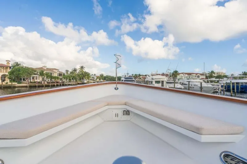 Slide: The Image of Christensen Tri-Deck 1995 yacht deck with seating, docked in a marina under blue skies. - 41