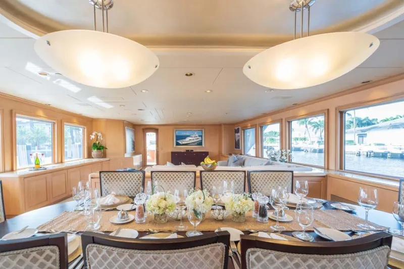 Slide: The Image of Luxurious dining area on 1995 Christensen Tri-Deck yacht with elegant table setting and large windows. - 8