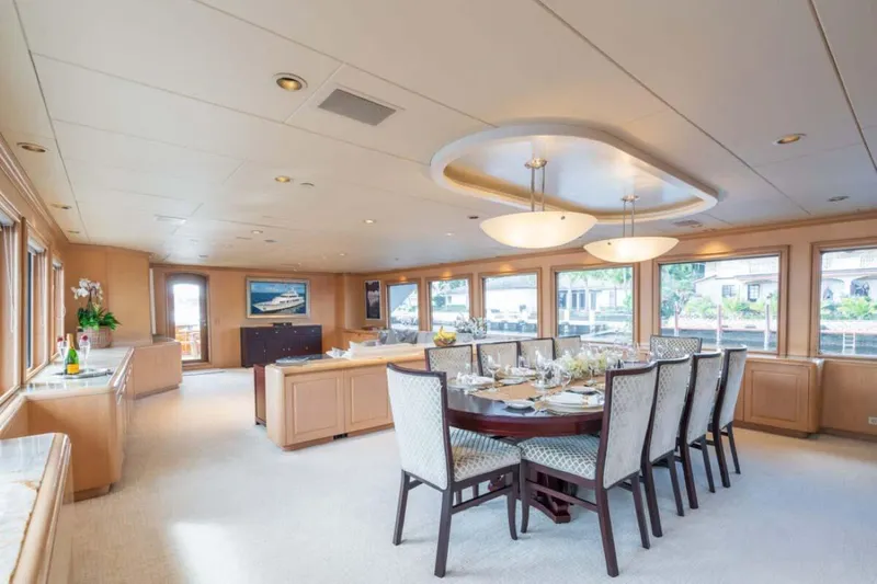 Slide: The Image of Luxurious dining area on 1995 Christensen Tri-Deck yacht, featuring elegant decor and large windows. - 9