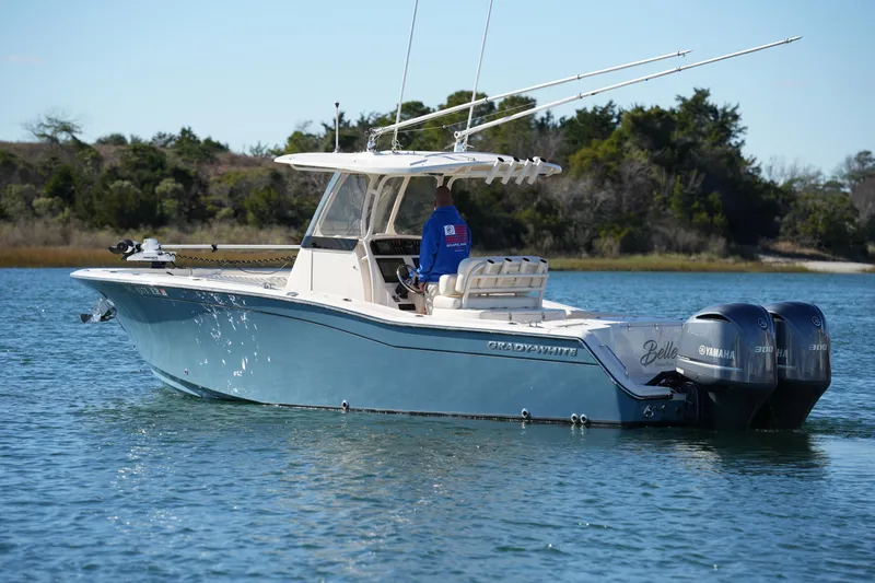 Slide: The Image of 2021 Grady-White Canyon 271 boat on water with dual Yamaha engines. - 15
