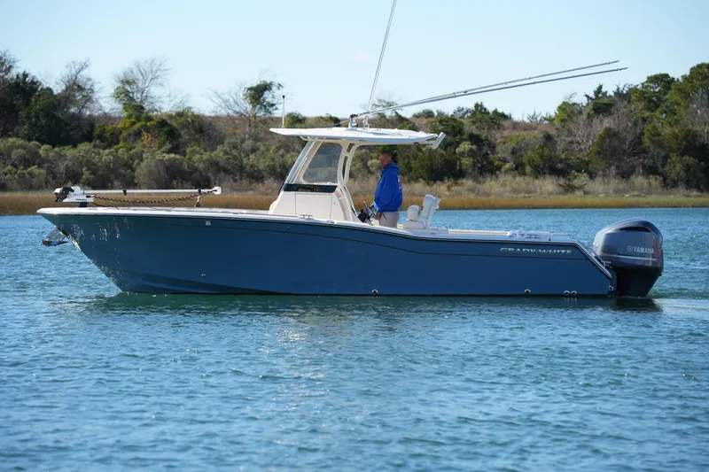 Slide: The Image of 2021 Grady-White Canyon 271 boat on calm water, side view. - 16
