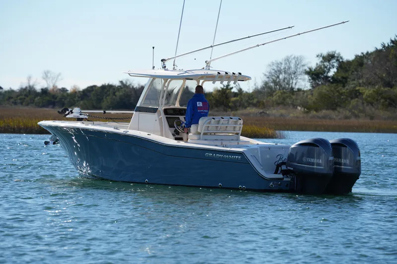 Slide: The Image of 2021 Grady-White Canyon 271 boat with dual Yamaha engines on calm water. - 20