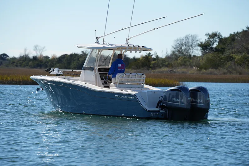 Slide: The Image of 2021 Grady-White Canyon 271 boat with dual Yamaha engines on calm water. - 21