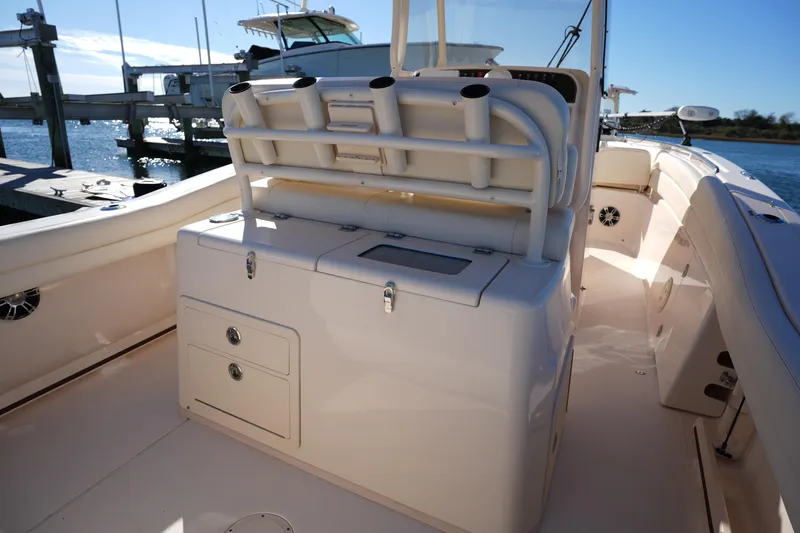Slide: The Image of 2021 Grady-White Canyon 271 boat interior with rod holders and storage compartments. - 27