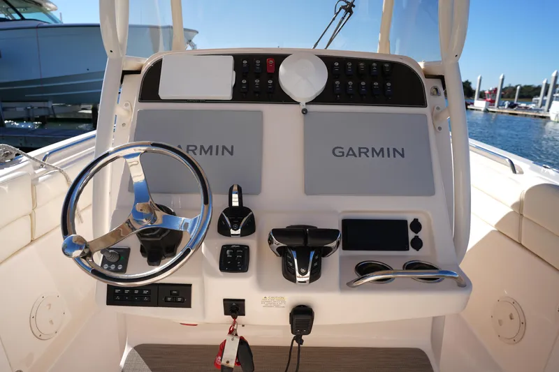 Slide: The Image of 2021 Grady-White Canyon 271 helm with Garmin navigation system and steering wheel. - 31