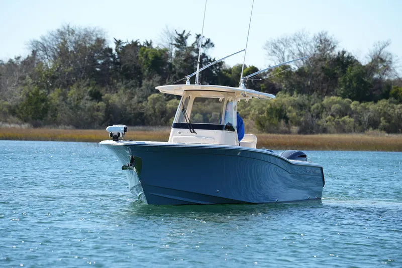 Slide: The Image of 2021 Grady-White Canyon 271 boat cruising on a serene lake. - 4