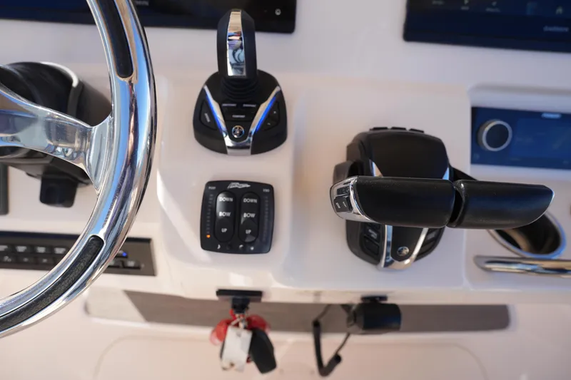 Slide: The Image of Control panel of 2021 Grady-White Canyon 271 boat with steering wheel and throttle. - 40