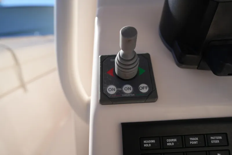 Slide: The Image of Control panel of 2021 Grady-White Canyon 271 boat with joystick and buttons. - 41