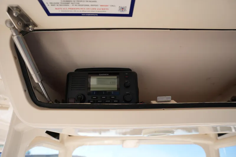 Slide: The Image of Garmin radio installed in 2021 Grady-White Canyon 271 boat's overhead compartment. - 44