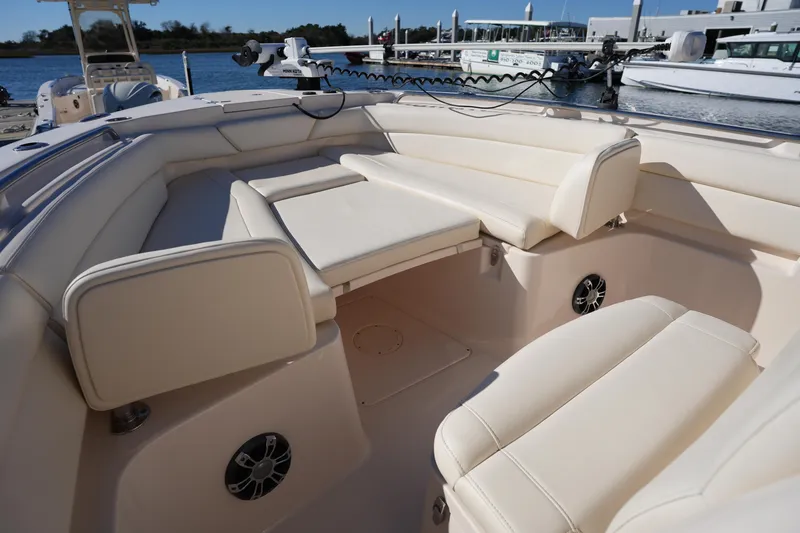 Slide: The Image of 2021 Grady-White Canyon 271 boat interior with beige seating and speakers. - 46