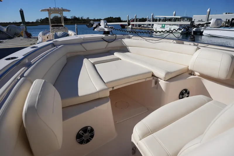 Slide: The Image of 2021 Grady-White Canyon 271 boat interior with plush seating at a marina. - 47