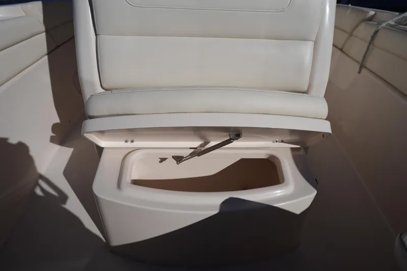 Slide: The Image of 2021 Grady-White Canyon 271 boat seat with storage compartment open. - 51
