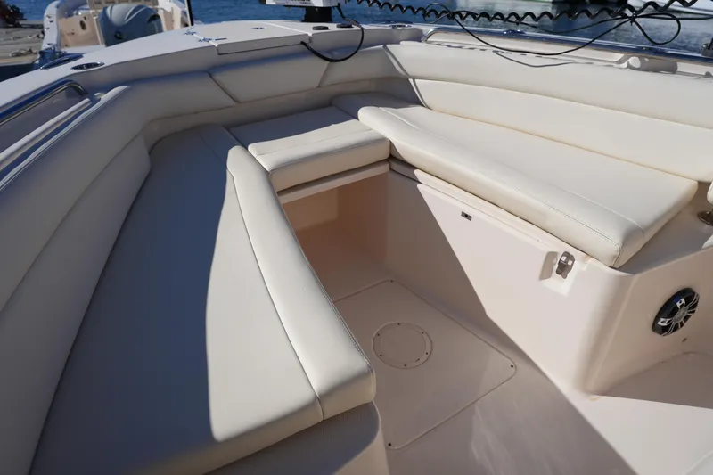 Slide: The Image of 2021 Grady-White Canyon 271 boat interior with cushioned seating and storage. - 52