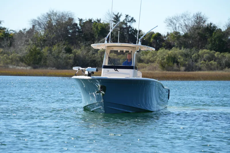 Slide: The Image of 2021 Grady-White Canyon 271 boat cruising on a serene lake. - 6