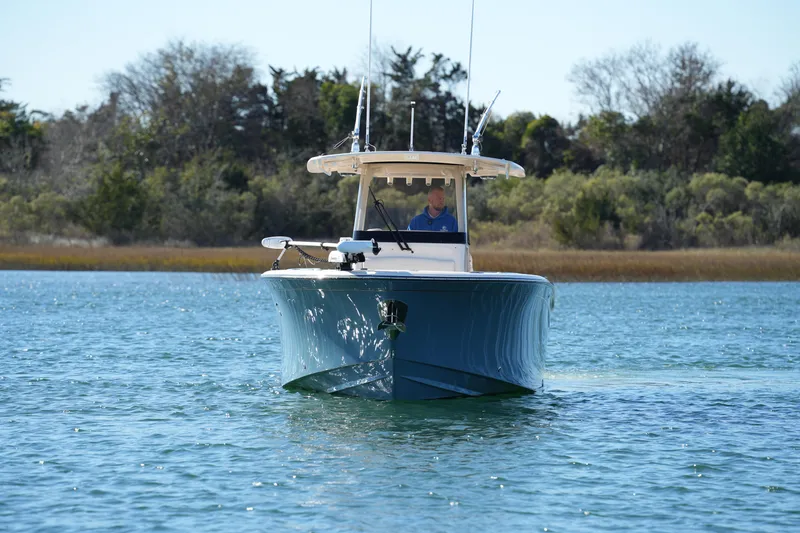 Slide: The Image of 2021 Grady-White Canyon 271 boat cruising on a serene lake. - 7