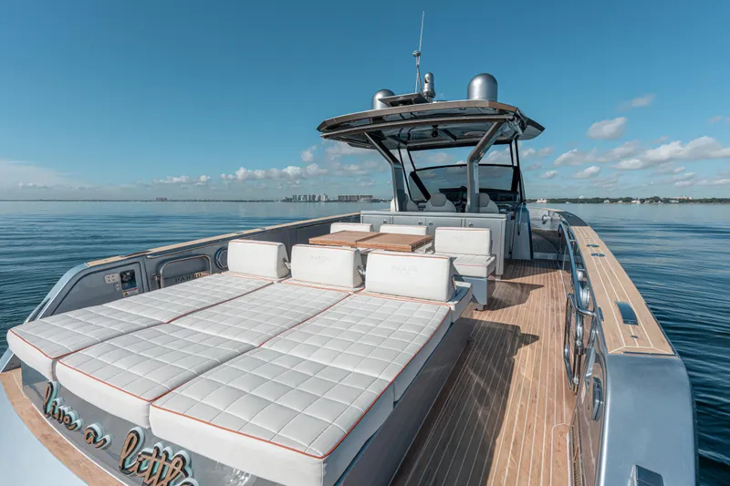 Slide: The Image of 2021 Pardo Yachts 43 luxury yacht with spacious deck and sunbeds on calm water. - 16