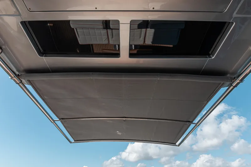 Slide: The Image of 2021 Pardo Yachts 43 sunshade and seating area under clear blue sky. - 35