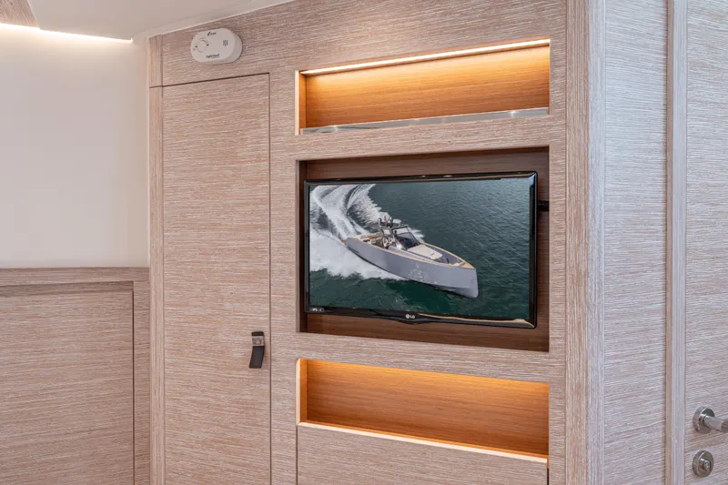 Slide: The Image of Interior of 2021 Pardo Yachts 43 with TV displaying yacht on water. - 38