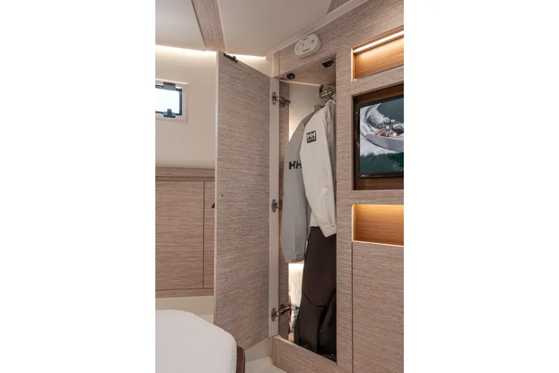 Slide: The Image of Interior of 2021 Pardo Yachts 43, featuring a stylish wardrobe with hanging clothes. - 41