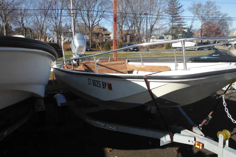 Slide: The Image of 1986 Boston Whaler 13 boat on trailer, parked outdoors, sunny day. - 16