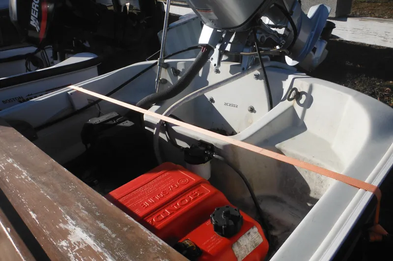 Slide: The Image of 1986 Boston Whaler 13 boat interior with Honda engine and fuel tank. - 8
