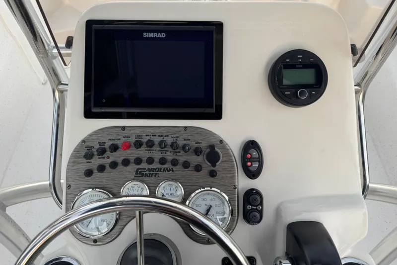 Slide: The Image of Control panel of 2016 Carolina Skiff 198 DLV boat with Simrad display and gauges. - 16