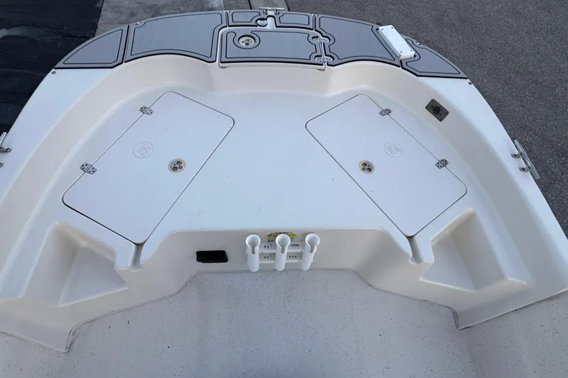 Slide: The Image of 2016 Carolina Skiff 198 DLV boat deck with storage compartments and rod holders. - 18