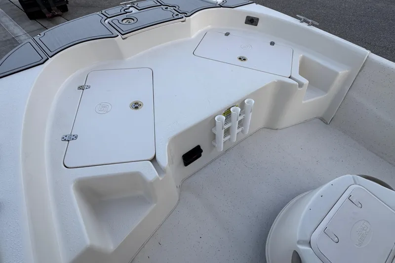 Slide: The Image of 2016 Carolina Skiff 198 DLV boat interior with storage compartments and rod holders. - 19