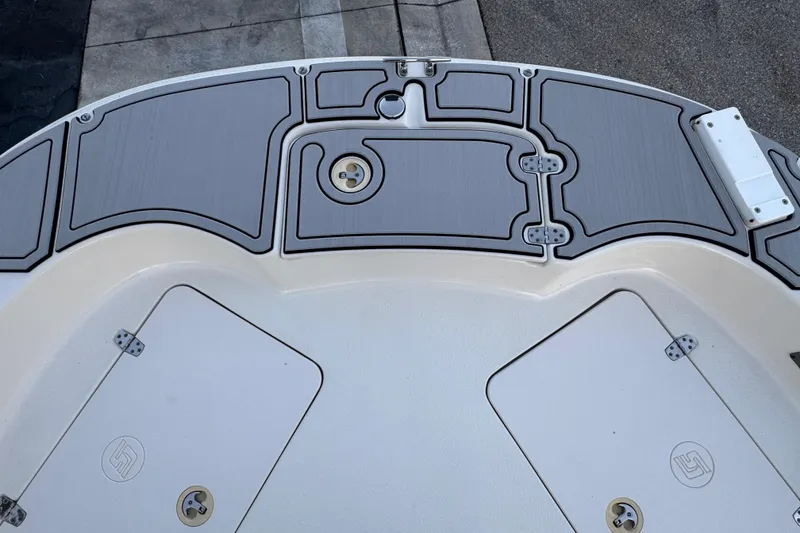 Slide: The Image of 2016 Carolina Skiff 198 DLV boat deck with storage compartments and non-slip surface. - 21