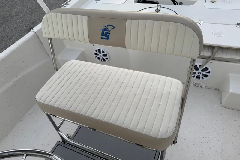 Slide: The Image of 2016 Carolina Skiff 198 DLV boat seat with logo, featuring white and beige upholstery. - 27