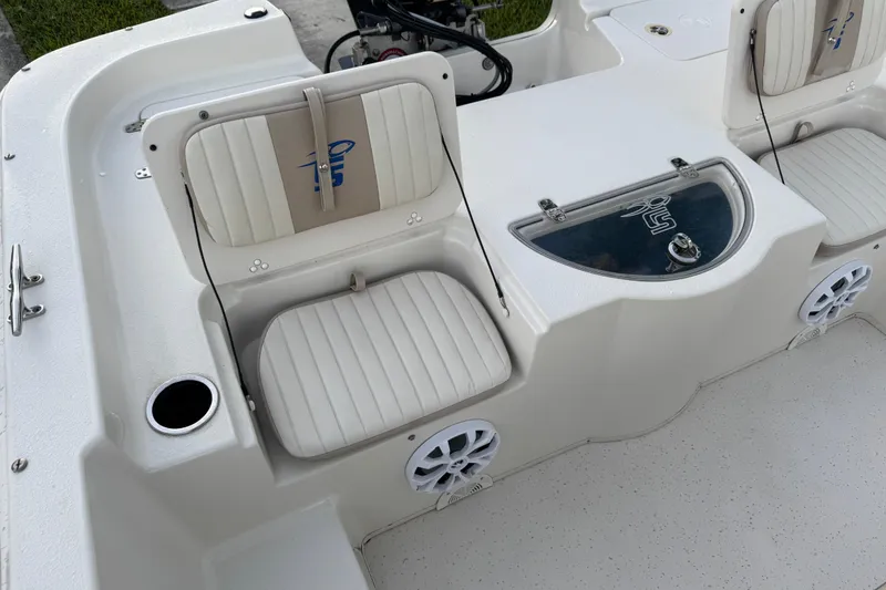Slide: The Image of 2016 Carolina Skiff 198 DLV boat interior with seating and storage compartments. - 30
