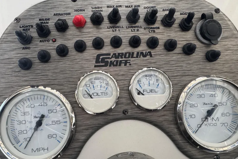 Slide: The Image of Control panel of a 2016 Carolina Skiff 198 DLV boat with gauges and switches. - 46