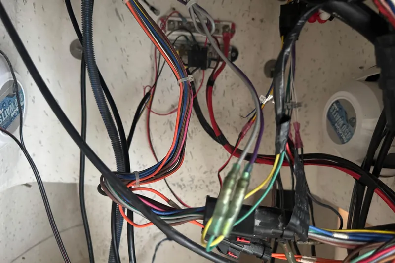 Slide: The Image of Wiring inside a 2016 Carolina Skiff 198 DLV boat, showing various colored cables and connectors. - 49