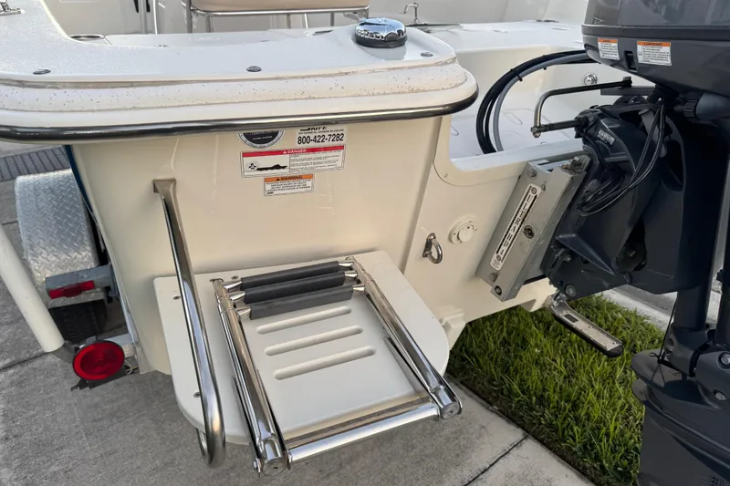 Slide: The Image of 2016 Carolina Skiff 198 DLV boat with motor and swim ladder. - 9