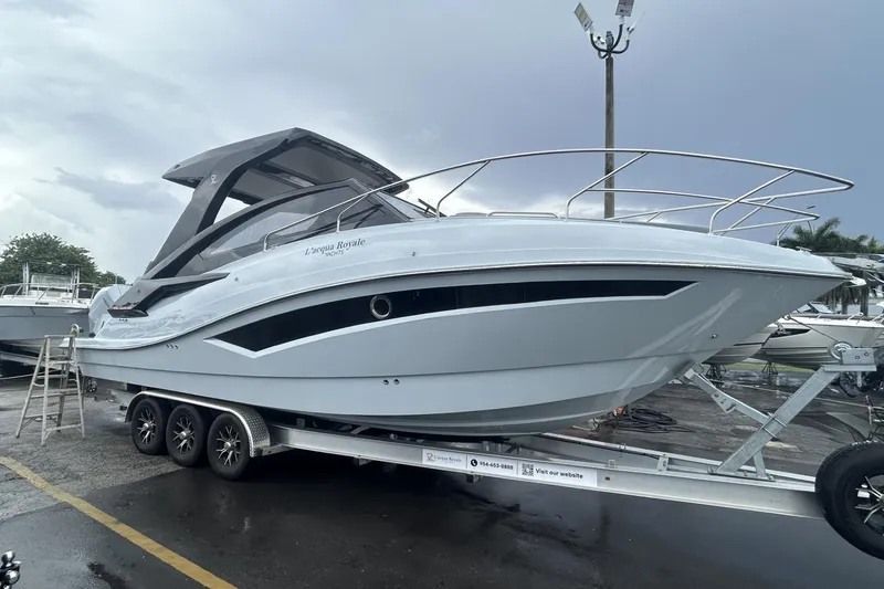 The Image of Luxury L'ACQUA LR350 boat on trailer, 2025 model, sleek design, parked outdoors. - 1