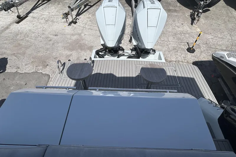 Slide: The Image of Rear view of 2025 L'ACQUA LR350 boat with dual outboard motors and deck seating. - 7