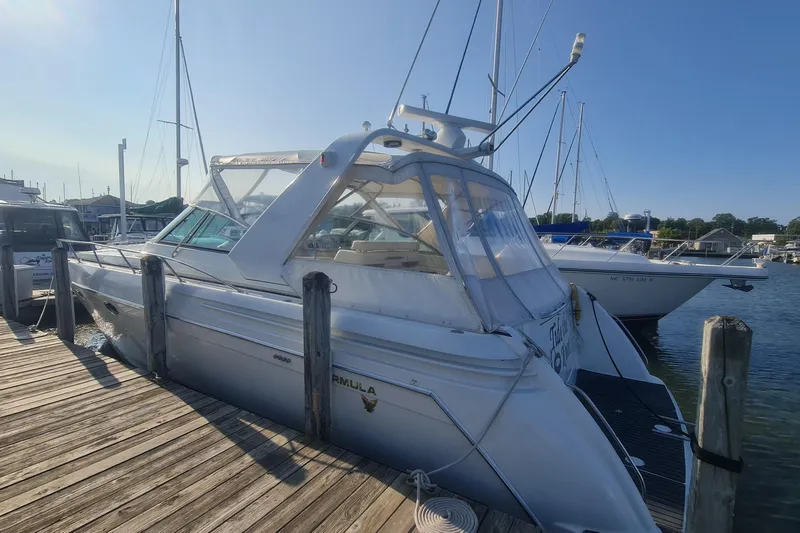 Slide: The Image of 1998 Formula 41 Performance Cruiser docked at marina under clear blue sky. - 1