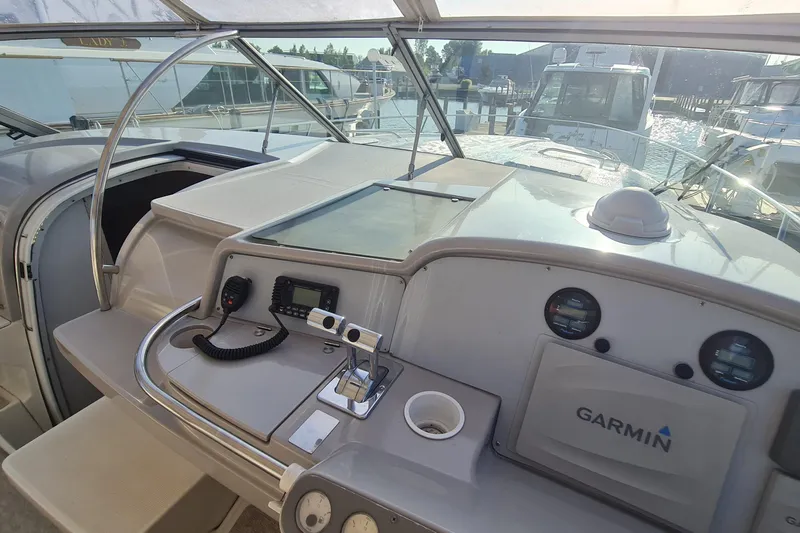 Slide: The Image of 1998 Formula 41 Performance Cruiser helm with Garmin navigation, docked at marina. - 12