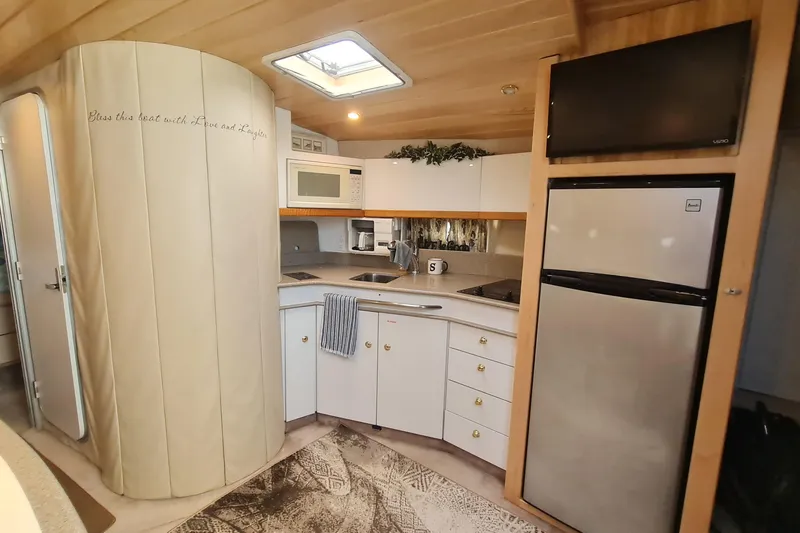 Slide: The Image of 1998 Formula 41 Performance Cruiser kitchen with modern appliances and cozy decor. - 15