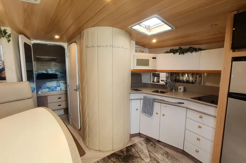 Slide: The Image of Interior of 1998 Formula 41 Performance Cruiser with modern kitchen and cozy bedroom. - 16