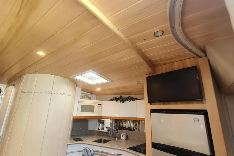 Slide: The Image of Interior of 1998 Formula 41 Performance Cruiser with modern kitchen and wood paneling. - 19