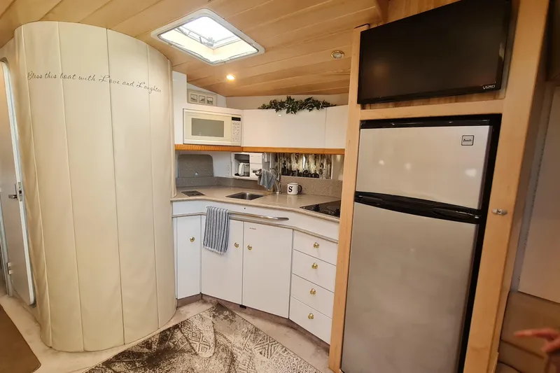 Slide: The Image of 1998 Formula 41 Performance Cruiser kitchen with modern appliances and cozy design. - 20