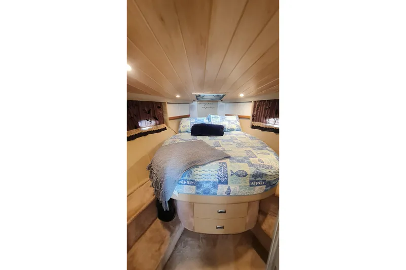 Slide: The Image of Cozy cabin interior of 1998 Formula 41 Performance Cruiser with nautical-themed bedding. - 21