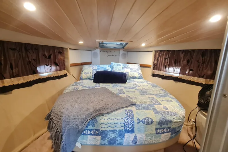Slide: The Image of Cozy cabin interior of 1998 Formula 41 Performance Cruiser with nautical-themed bedding. - 22