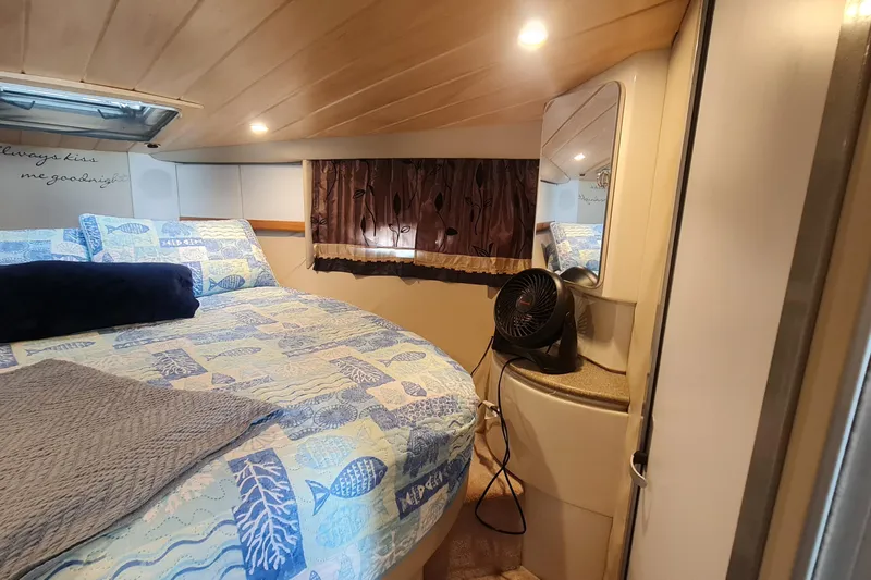 Slide: The Image of Cozy bedroom in 1998 Formula 41 Performance Cruiser with nautical-themed bedding. - 23