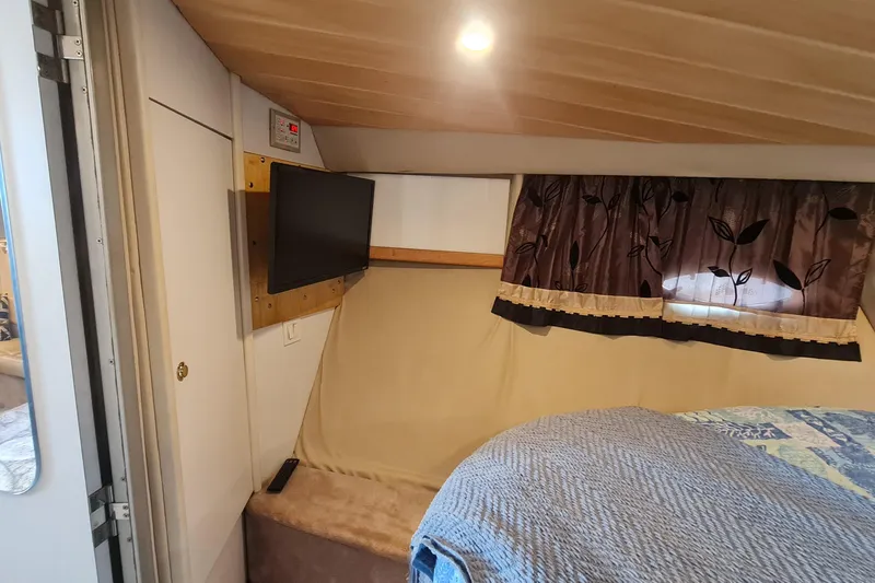 Slide: The Image of Cozy interior of a 1998 Formula 41 Performance Cruiser with TV and decorative curtains. - 24